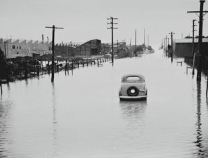Car abandoned in a flooded street.