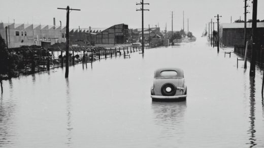 Car abandoned in a flooded street.